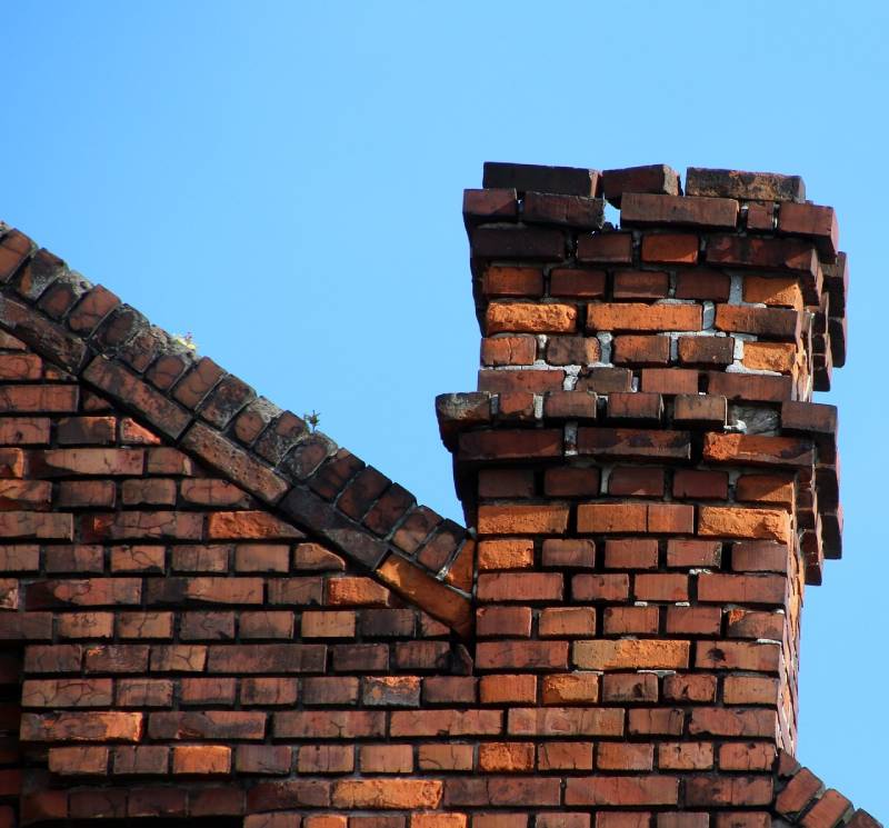 Damaged chimney on an Ramona home showing cracks and missing mortar